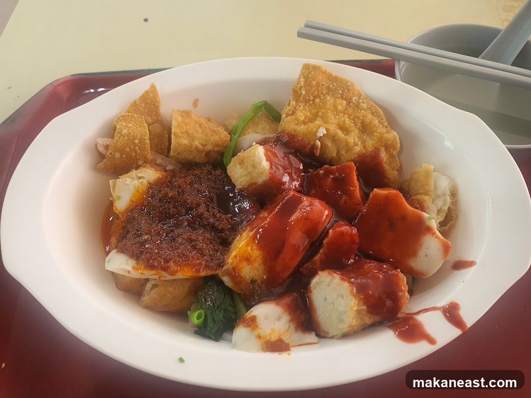 Bowl of noodles with sauce and toppings
