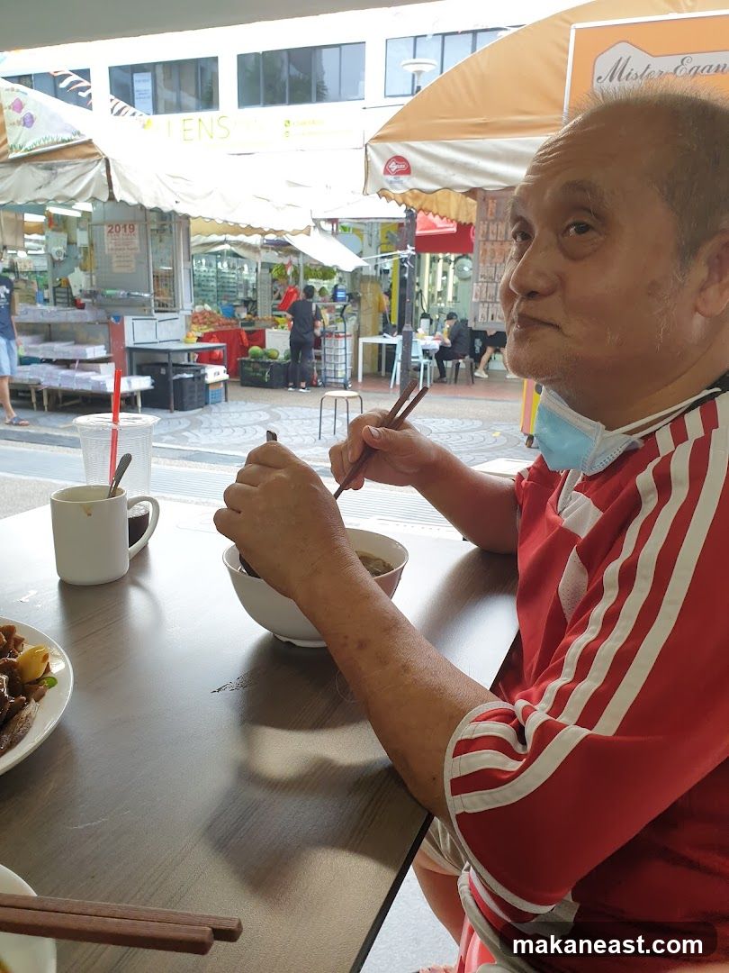 Man Eating Noodles at Outdoor Food Stall