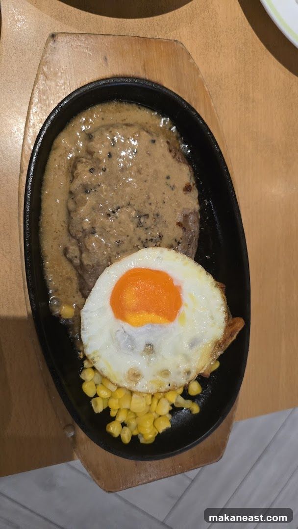 Sizzling Steak with Fried Egg and Corn