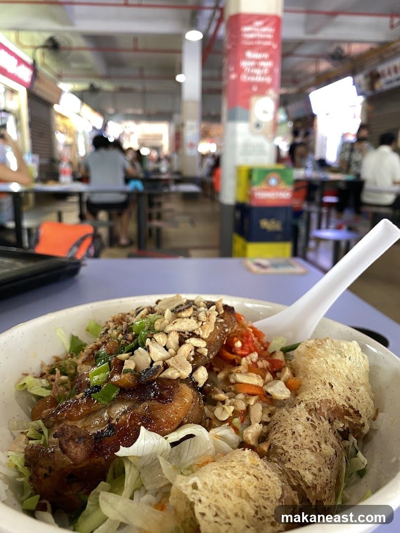 Bowl of food with chicken and spring rolls