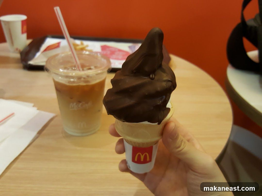 Chocolate-dipped ice cream cone and iced coffee