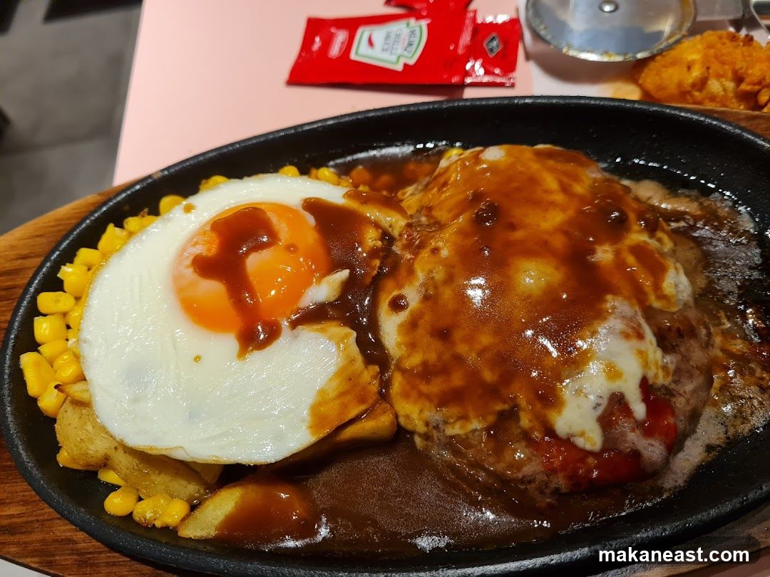 Hamburger steak with fried egg and corn