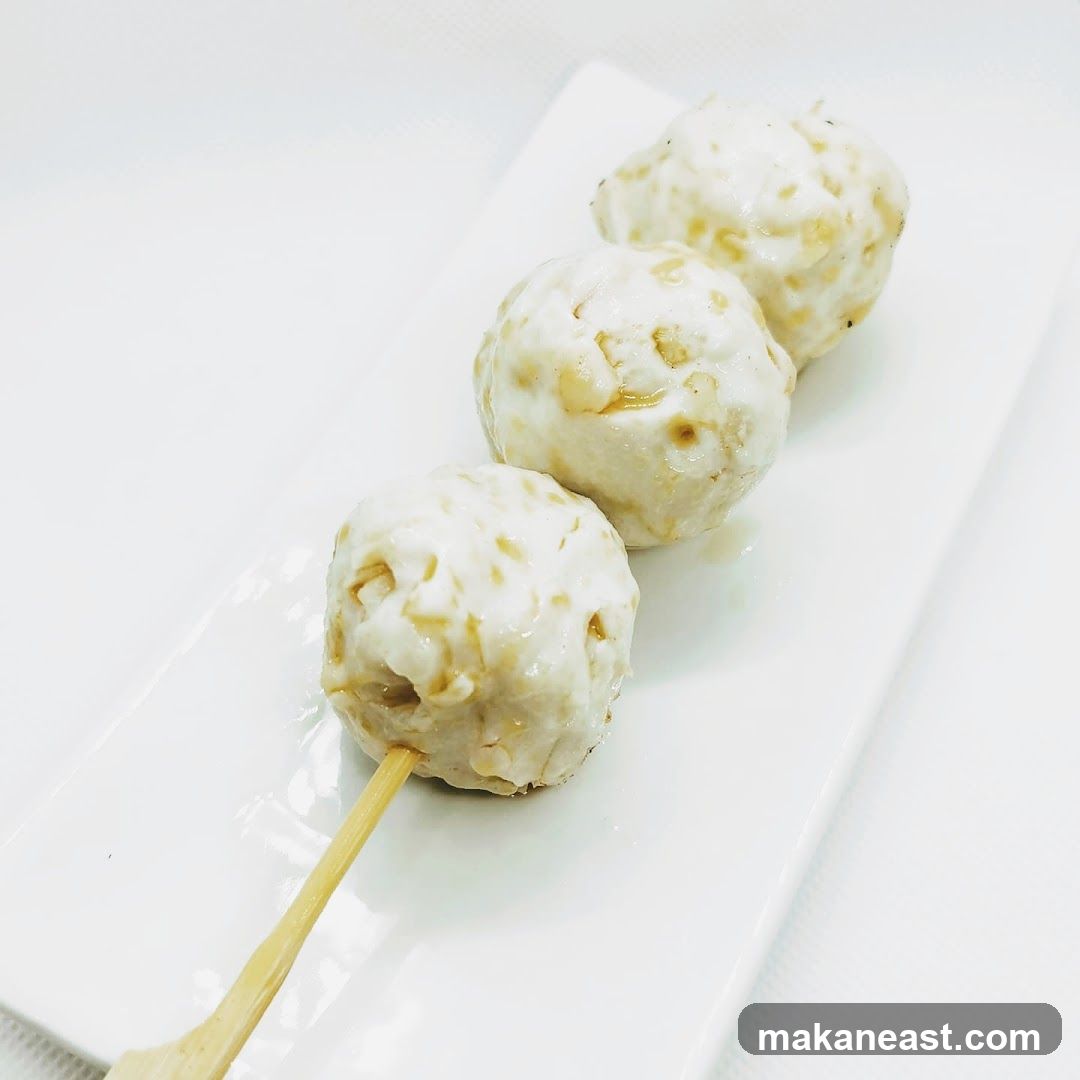 Three meatballs on a skewer