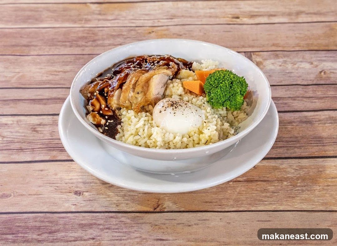Rice bowl with sliced duck, egg, broccoli, and carrots