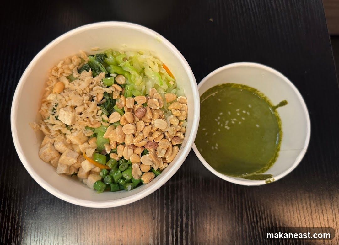 Bowl of food with side sauce
