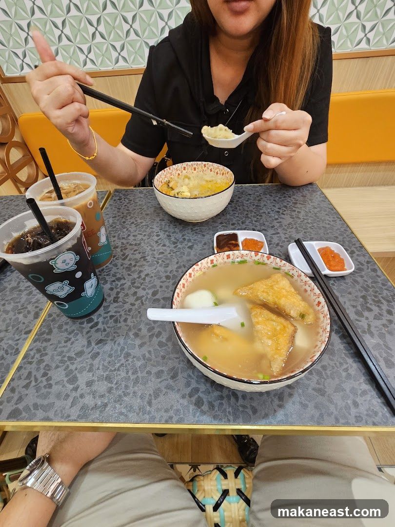 People eating noodles and drinks