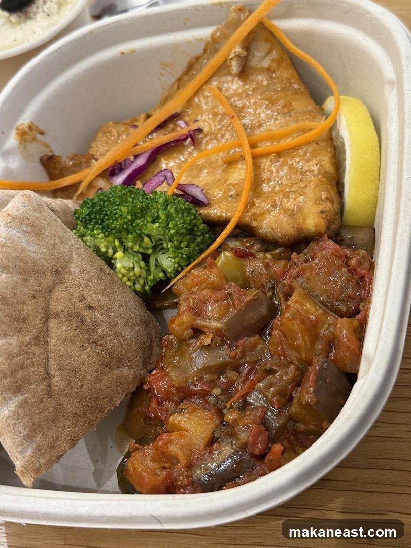 Fish dish with vegetables and pita