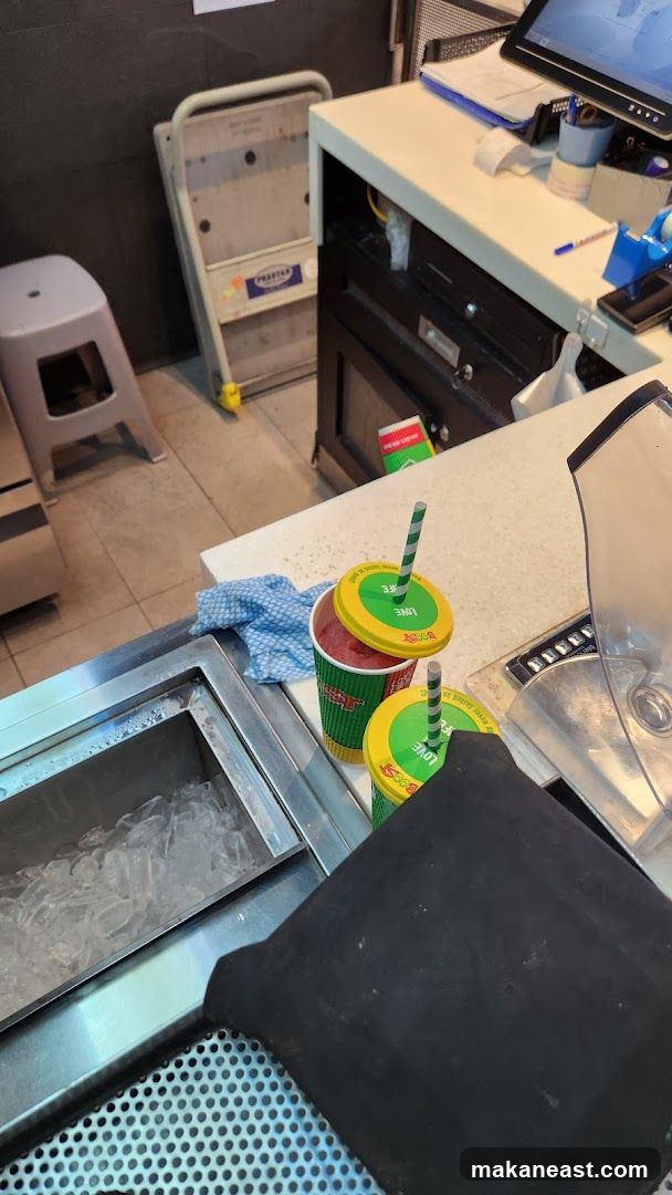 Two drinks with straws on a counter
