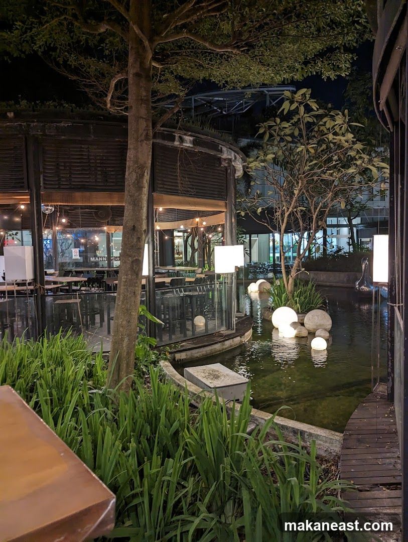 Outdoor seating area with pond and lights