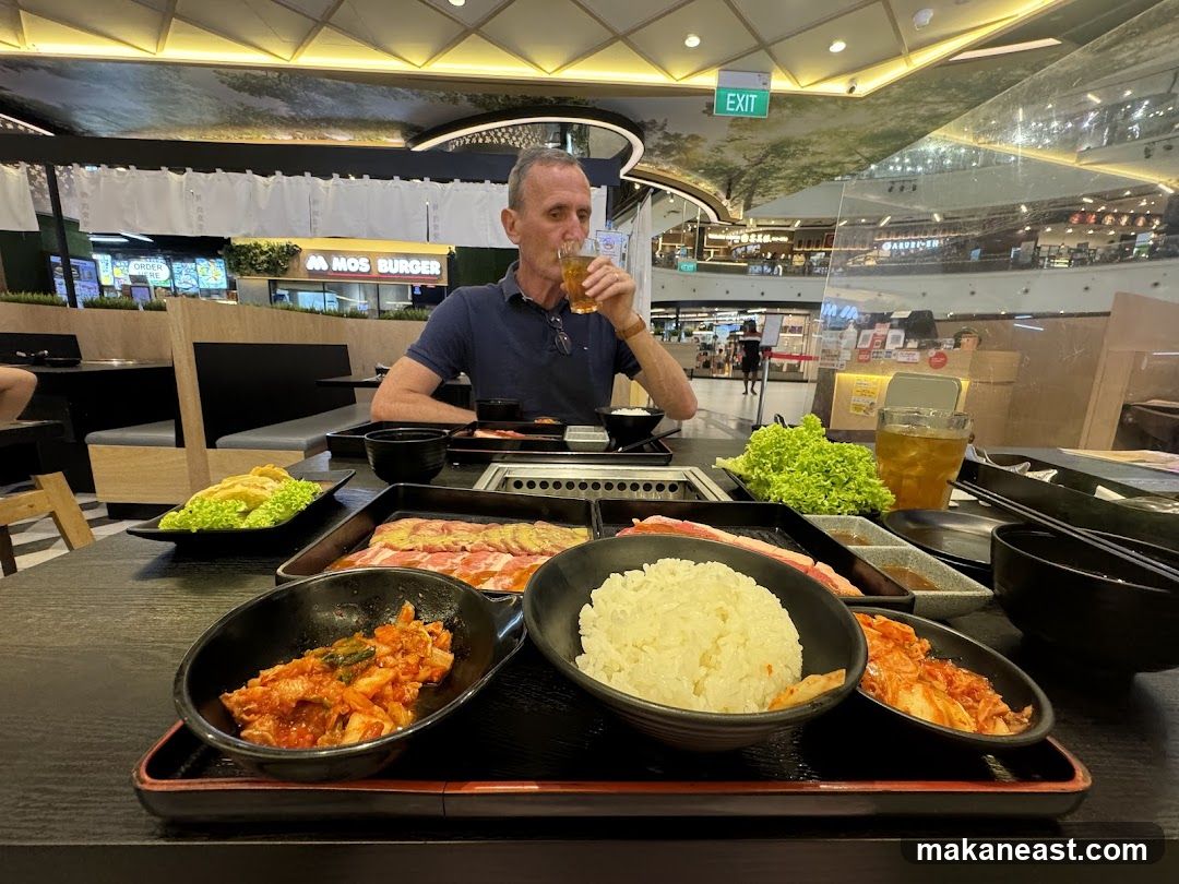 Man drinking at a Korean BBQ restaurant