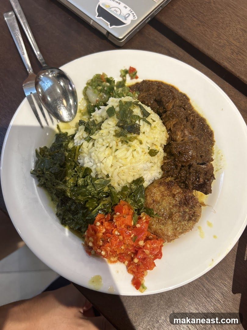 Plate of food with rice, meat, and vegetables