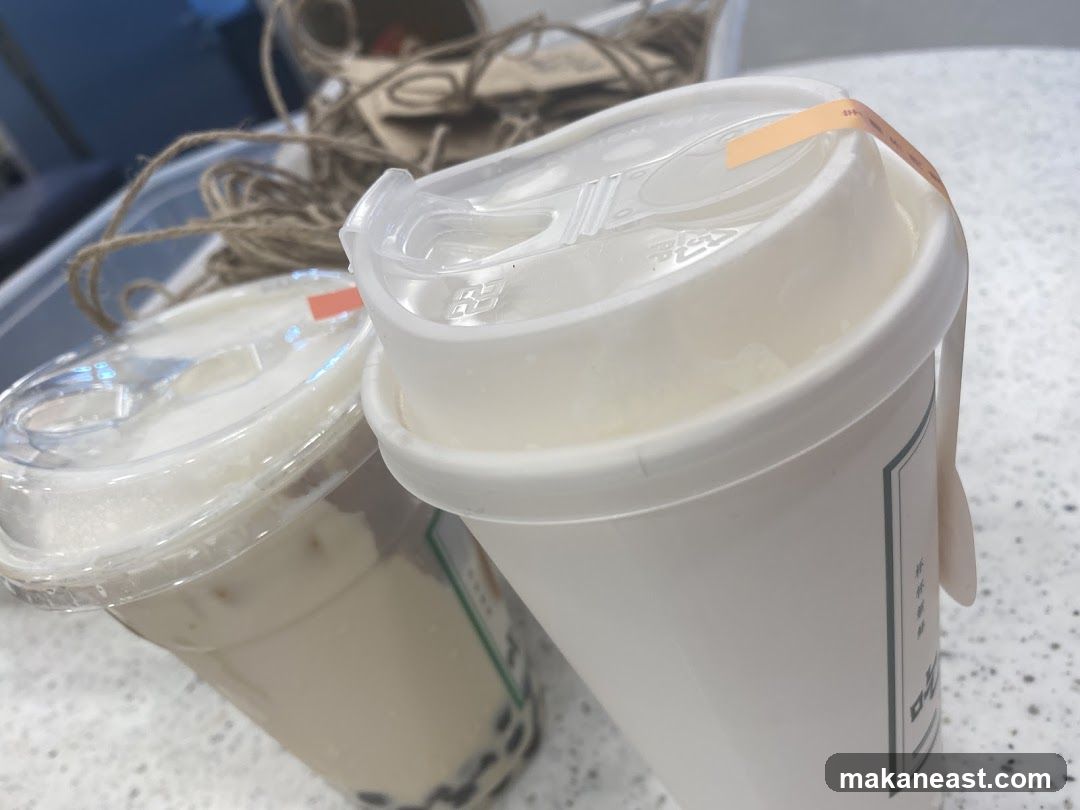 Two drinks with lids