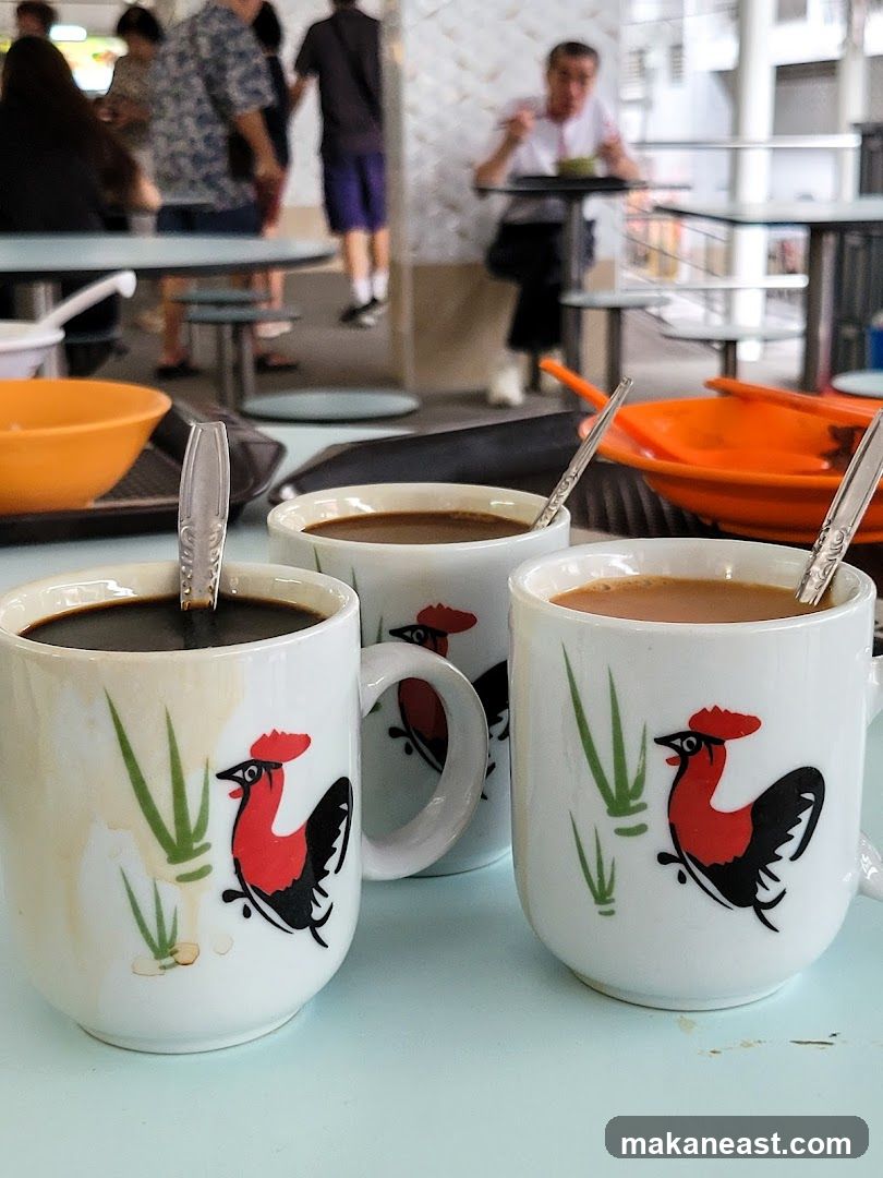 Three cups of coffee with rooster design