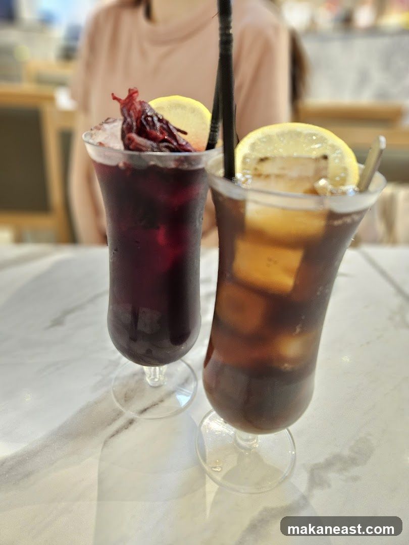 Two iced drinks with lemon slices