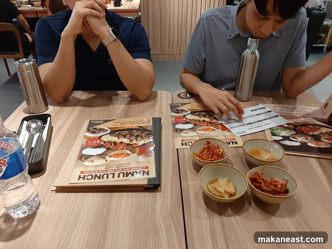 Diners at a table with food and menus