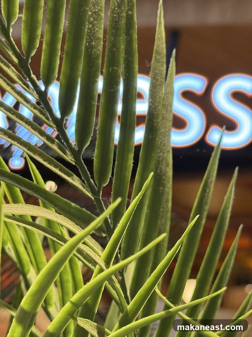 Neon Sign Behind Plant