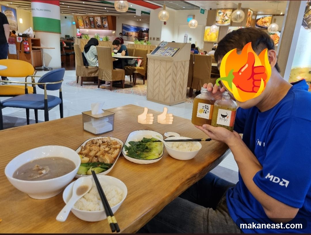 Man holding drinks at a food court