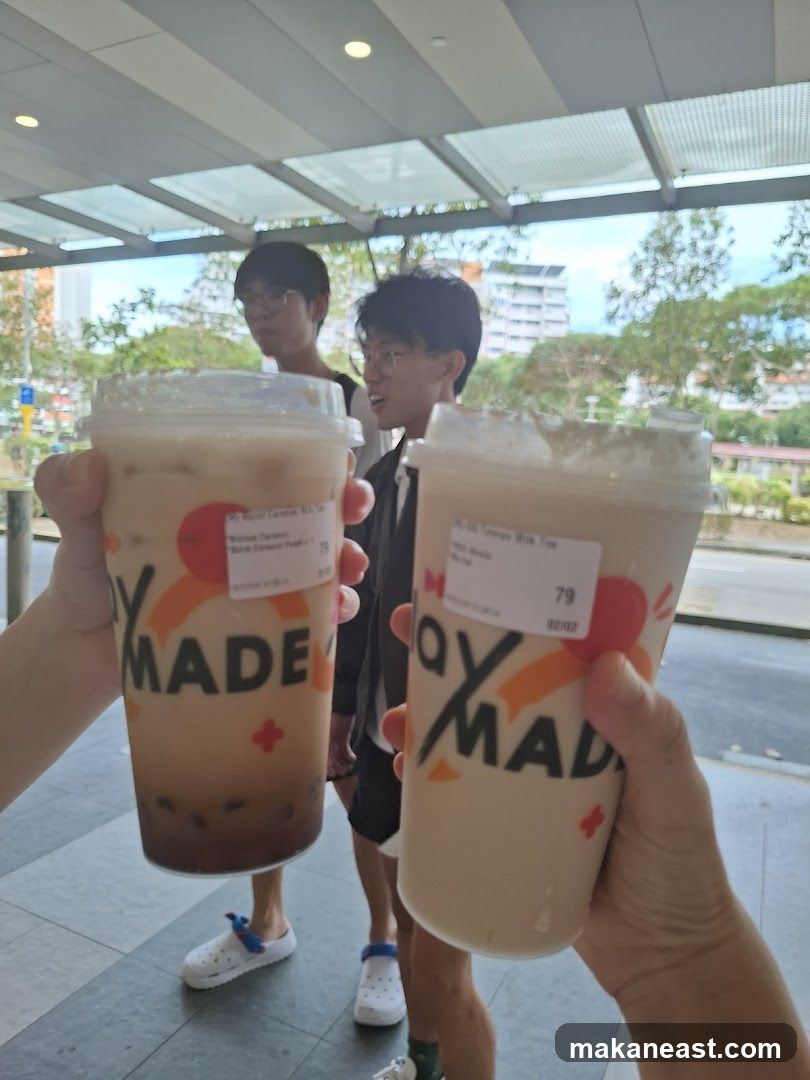 Two people holding bubble tea drinks