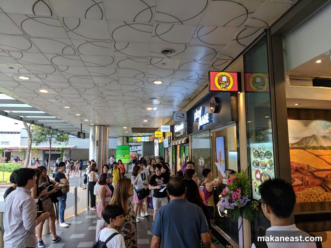 People queuing at a food establishment