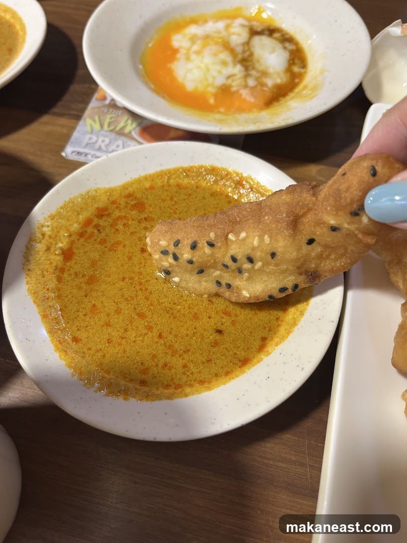 Dipping Fried Dough Stick into Sauce