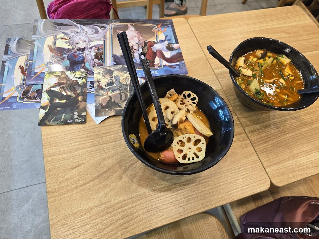 Two bowls of food on a table with anime-style cards
