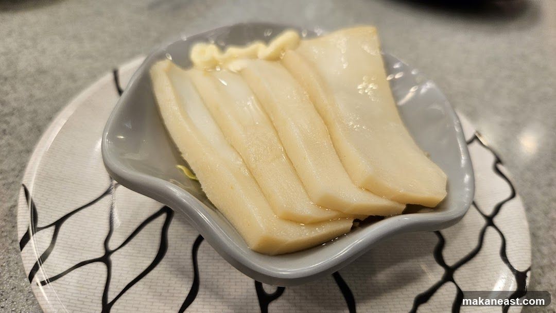Sliced white food with sauce