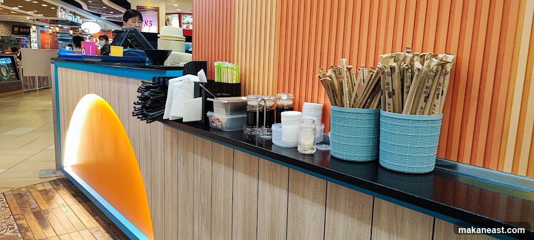 Condiments and Utensils at a Food Counter