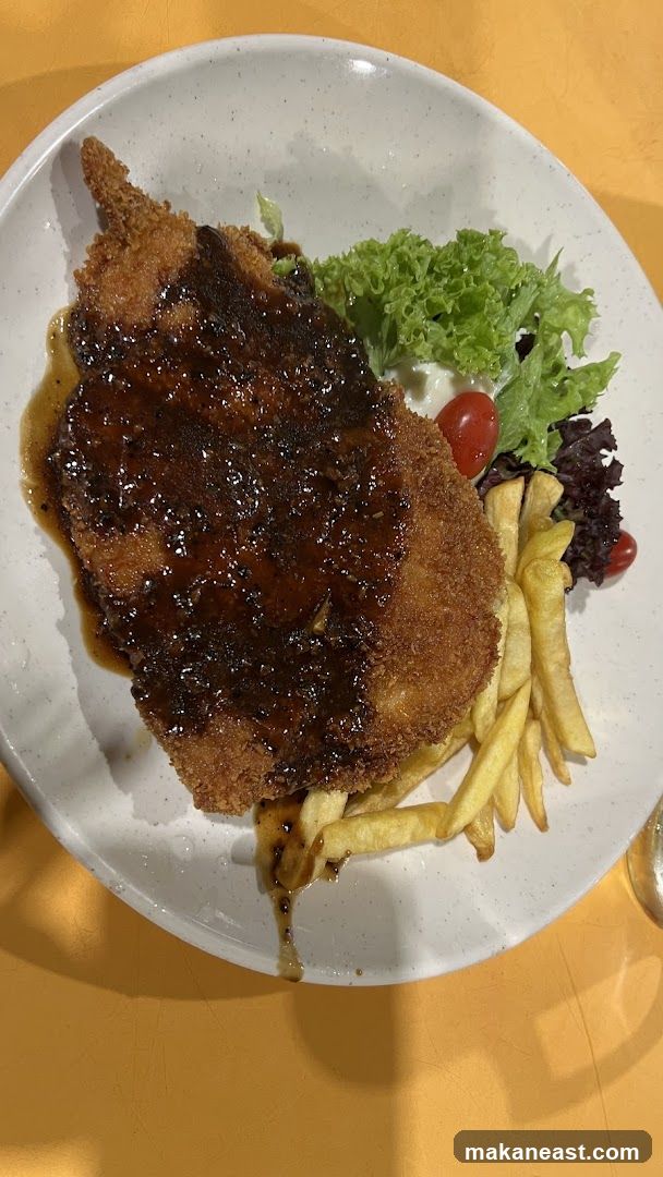 Breaded cutlet with sauce and fries