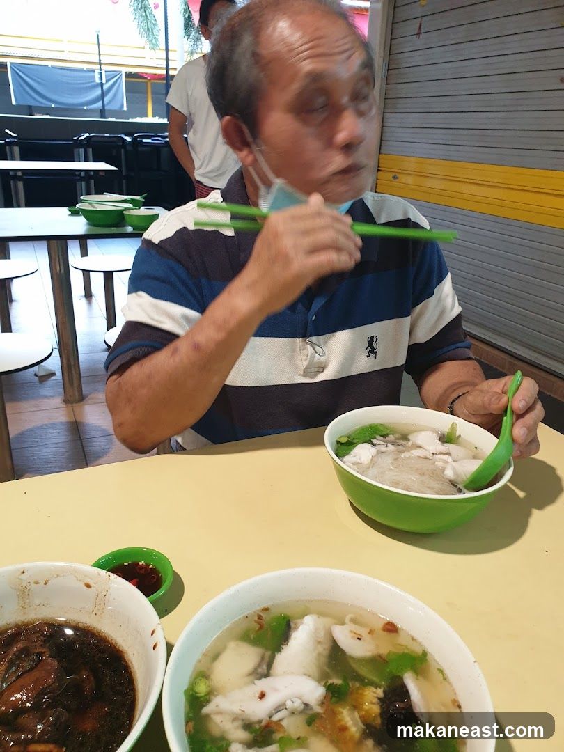 Man Eating Fish Soup