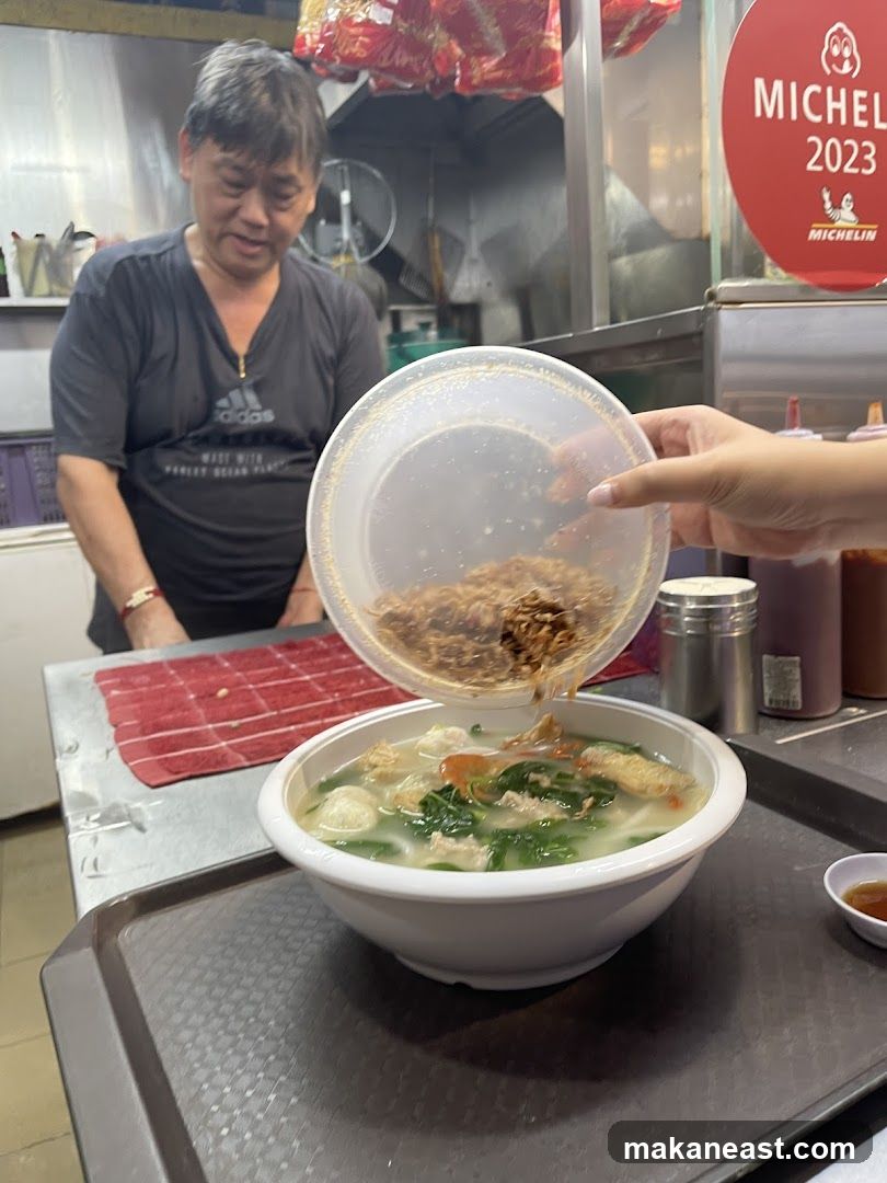 Chef adding toppings to soup