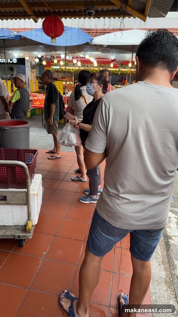 People queuing at a market stall