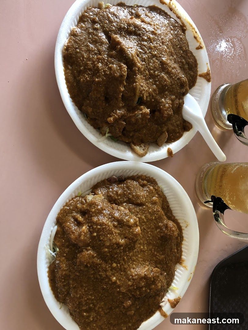 Two plates of food with peanut sauce