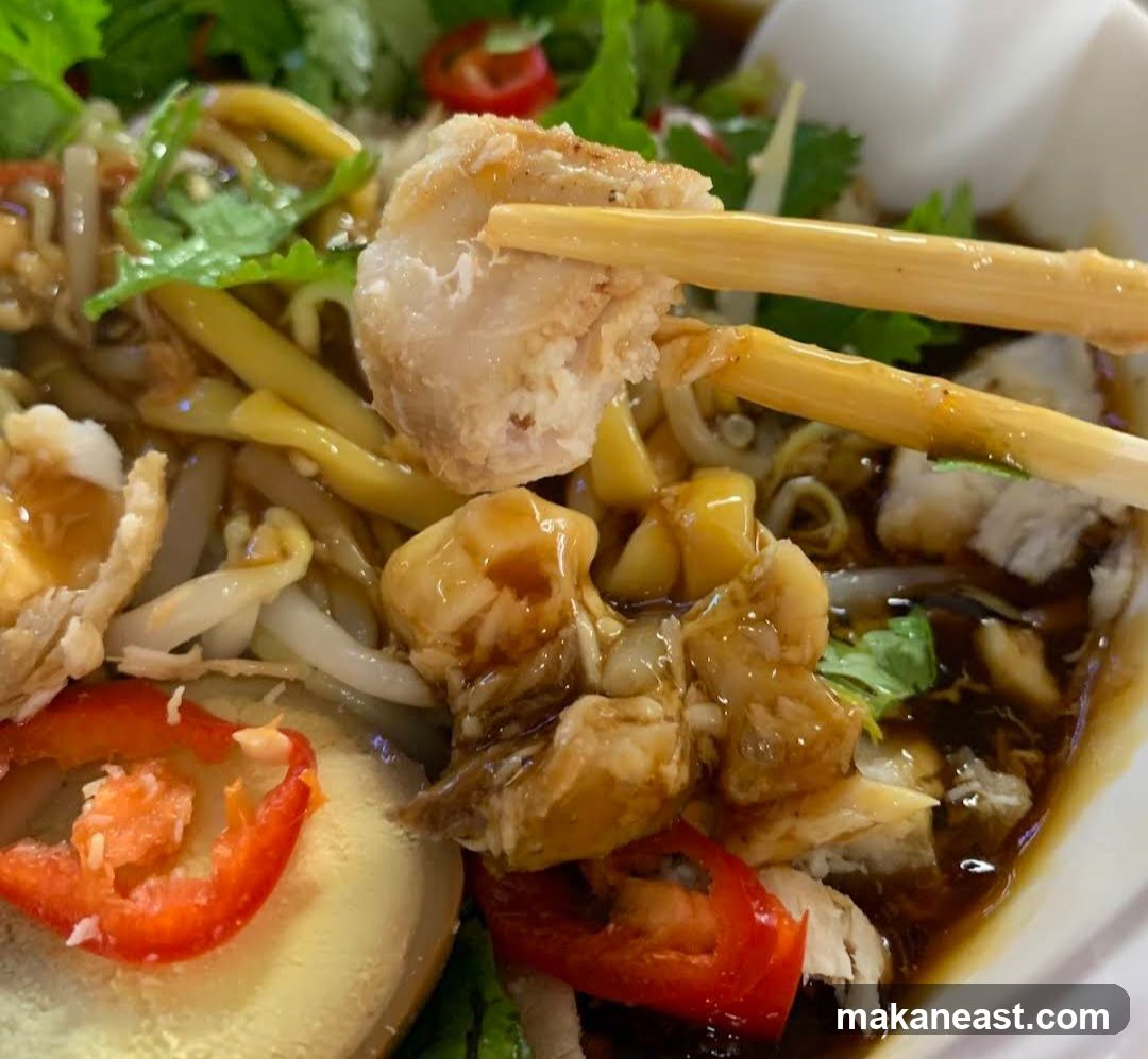 Close-up of a bowl of noodles with meat and vegetables