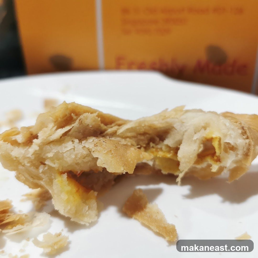 Close-up of a flaky pastry with filling