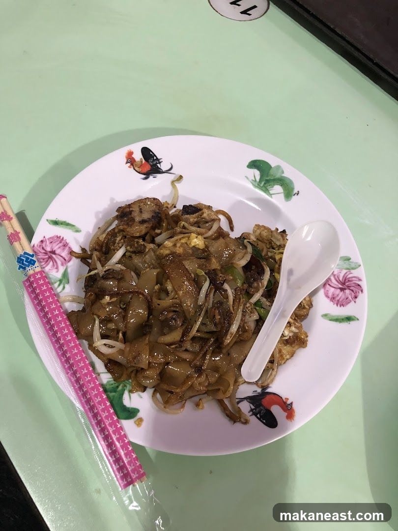 Plate of noodles with chopsticks and spoon