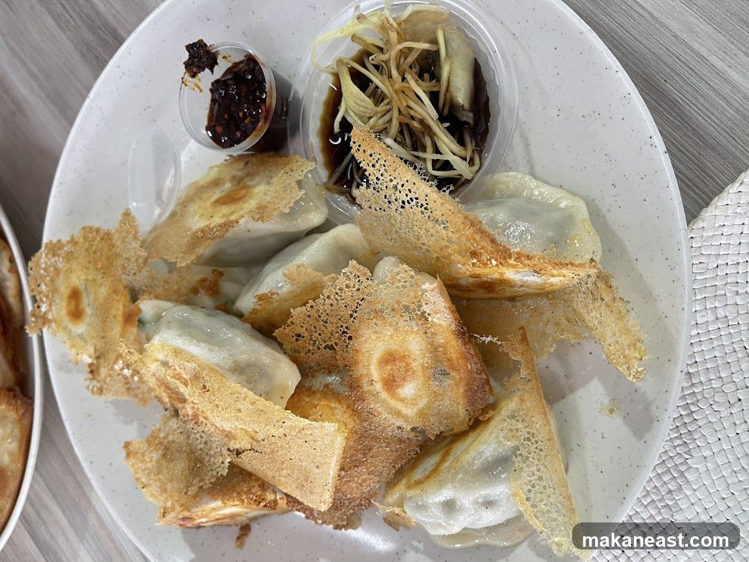 Pan-fried dumplings with dipping sauce