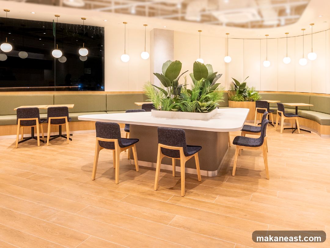Modern Cafe Interior with Green Booth Seating and Plants