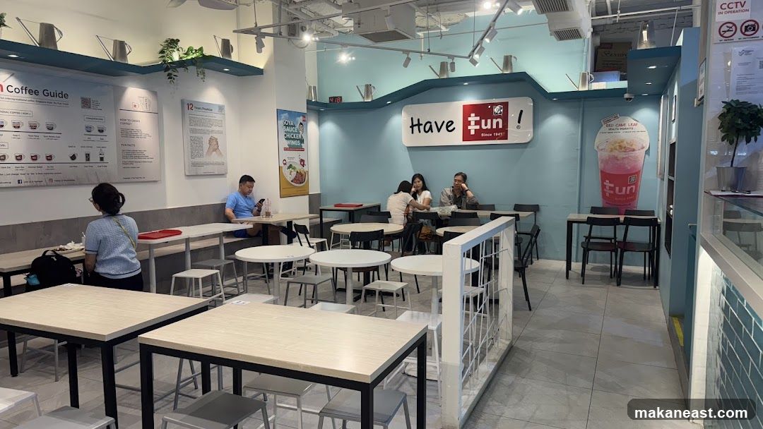 Interior of a cafe with seating and menu boards