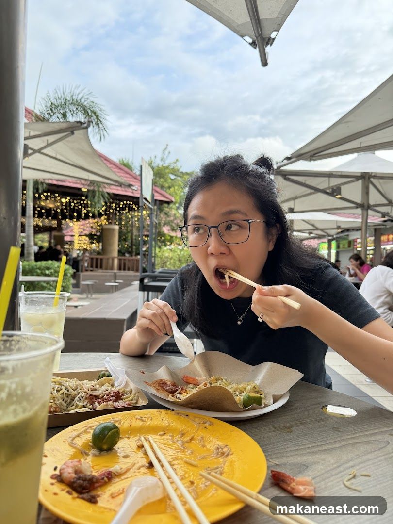 Woman Eating Noodles at Outdoor Food Court
