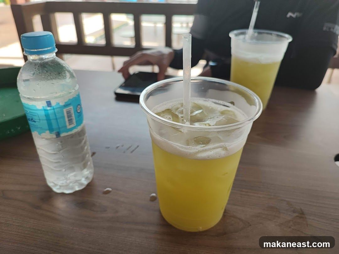 Two drinks and a bottle of water on a table