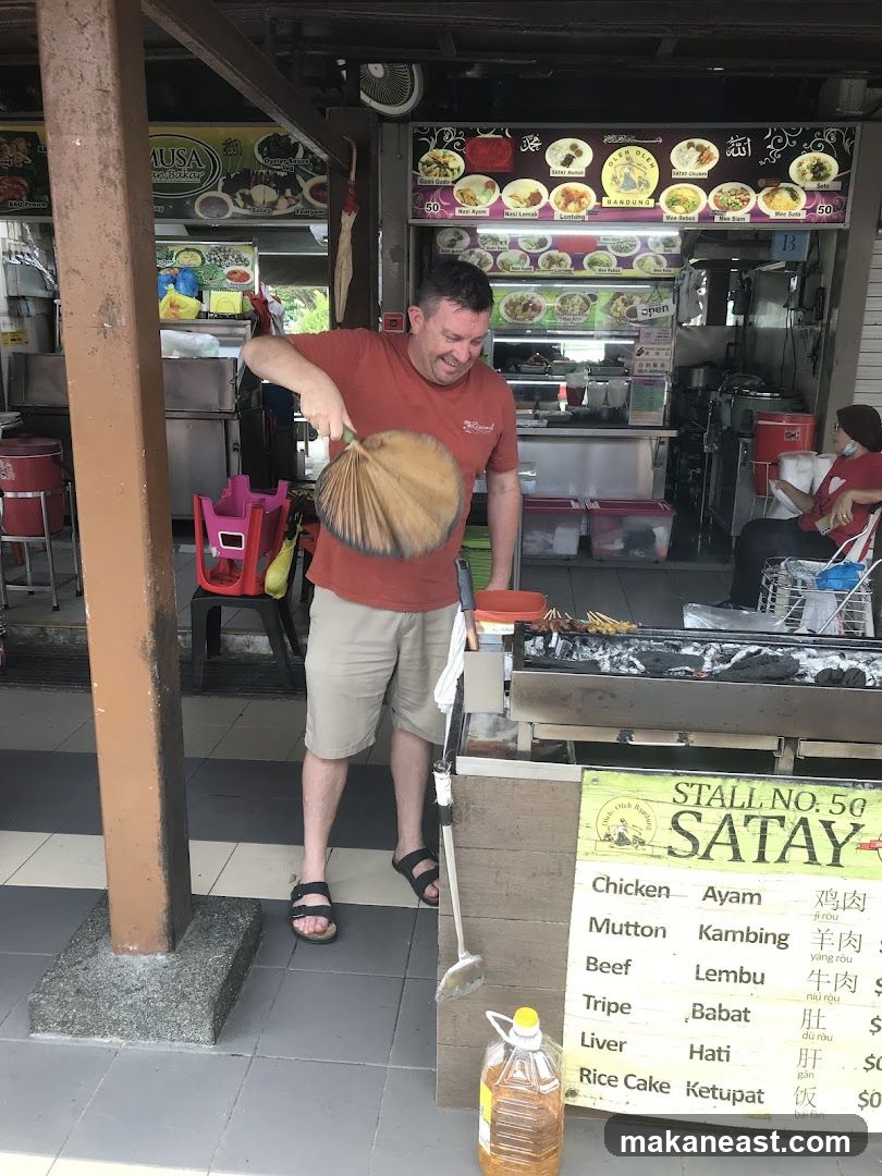 Man Fanning Satay Grill