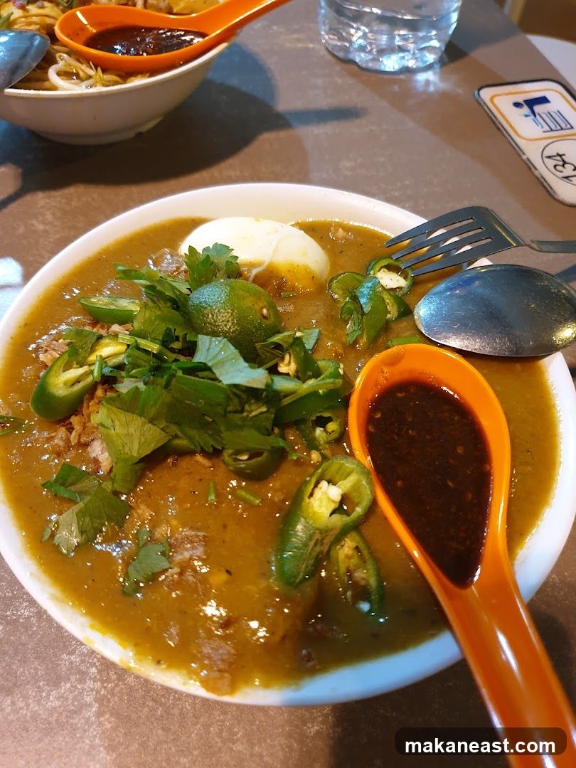 Bowl of Curry Laksa with Chili and Egg