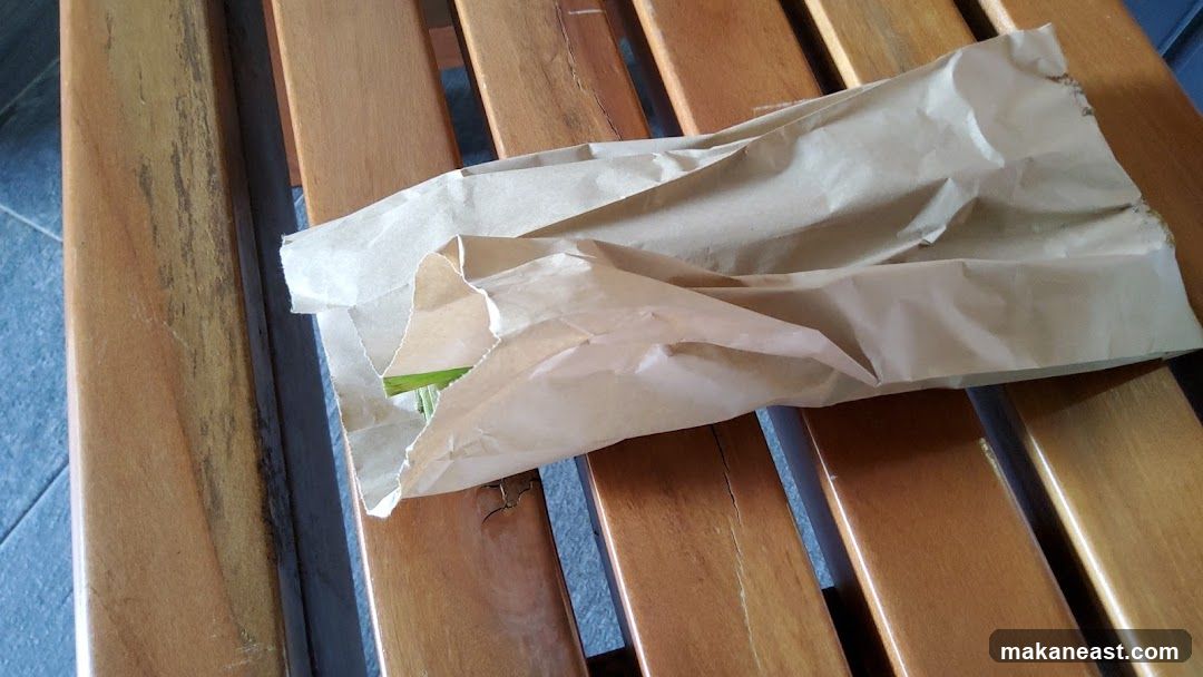 Brown paper bag on wooden slats