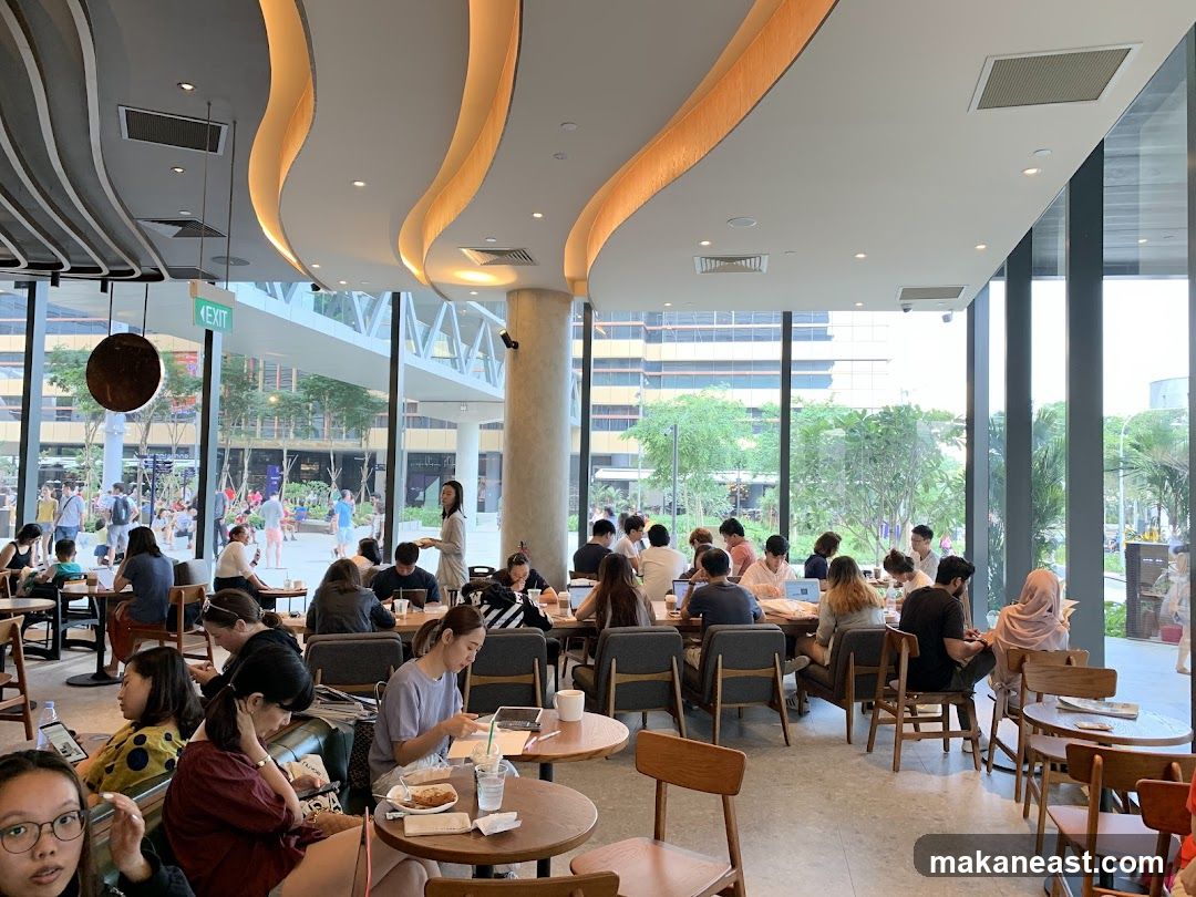 Busy cafe interior with patrons working and socializing