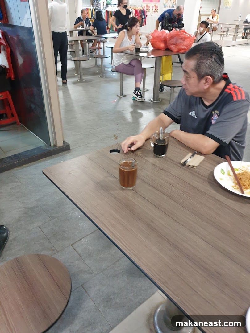 People eating at tables in a food court