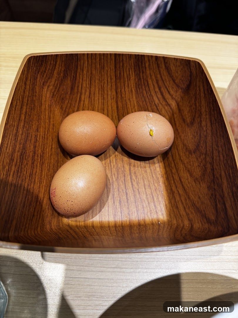 Three eggs in a wooden bowl