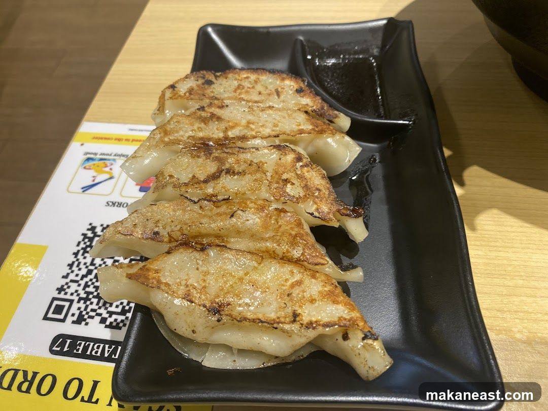 Pan-fried dumplings with dipping sauce