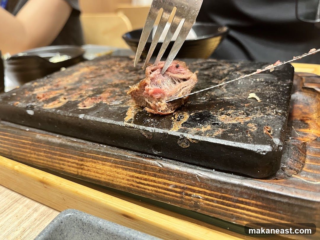 Steak being cut on a hot stone