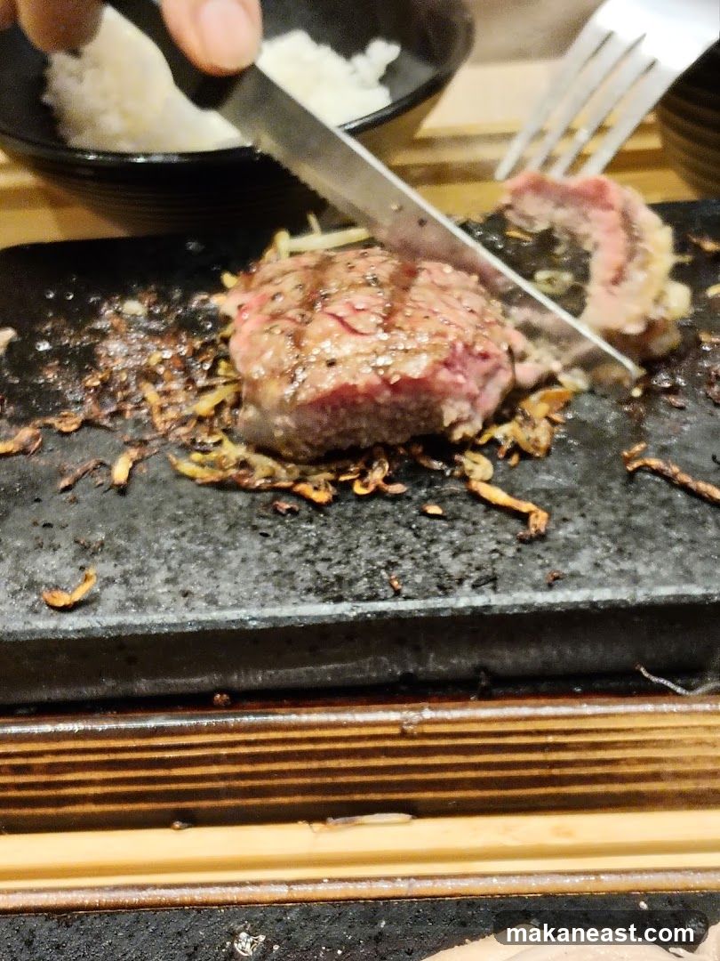 Steak being cut on a hot stone