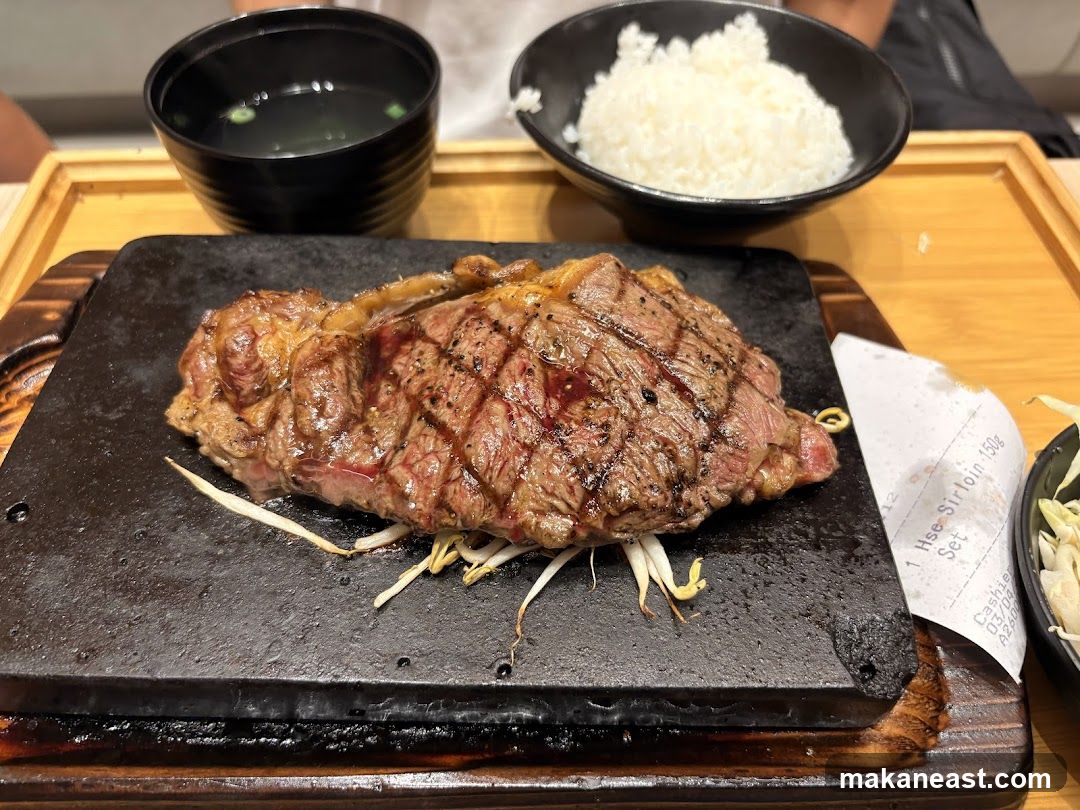 Steak on a hot stone with rice and soup